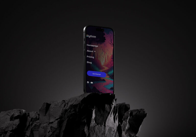 Smartphone displaying colorful website interface on rocky surface.